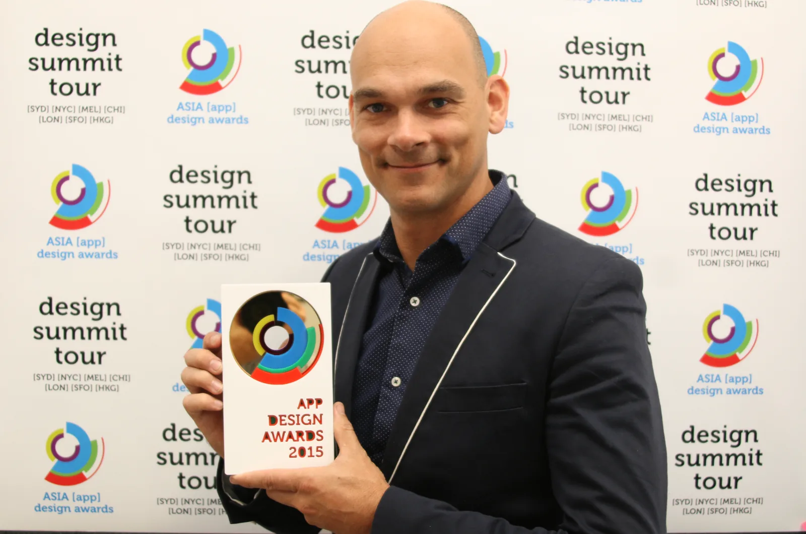 Adaptive Media holding the 2015 Asia App Design Awards trophy